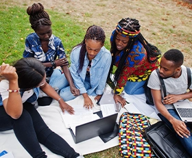 Students brainstorming on field